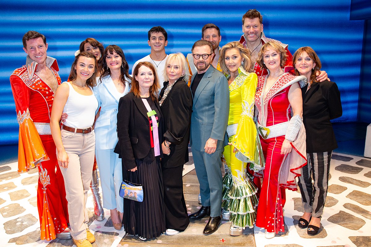 25 Years of MAMMA MIA centre Catherine Johnson, Judy Craymer, Bjorn Ulvaeus with cast onstage at Novello Theatre credit Piers Allardyce